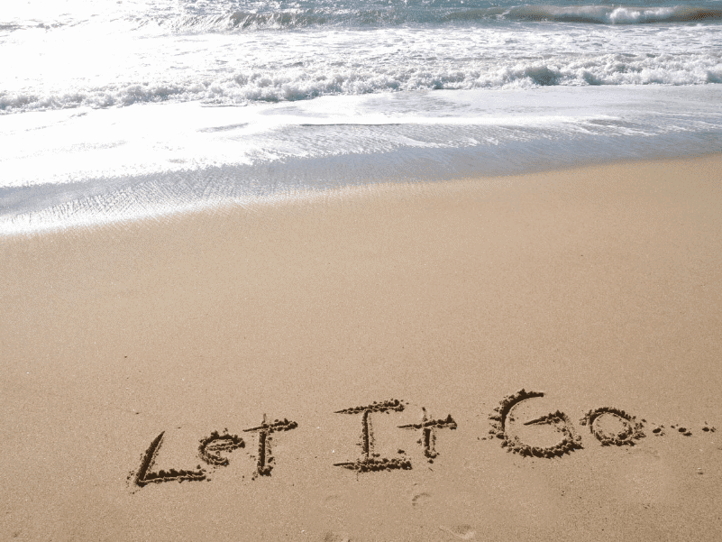 Let It Go written in sand on beach
