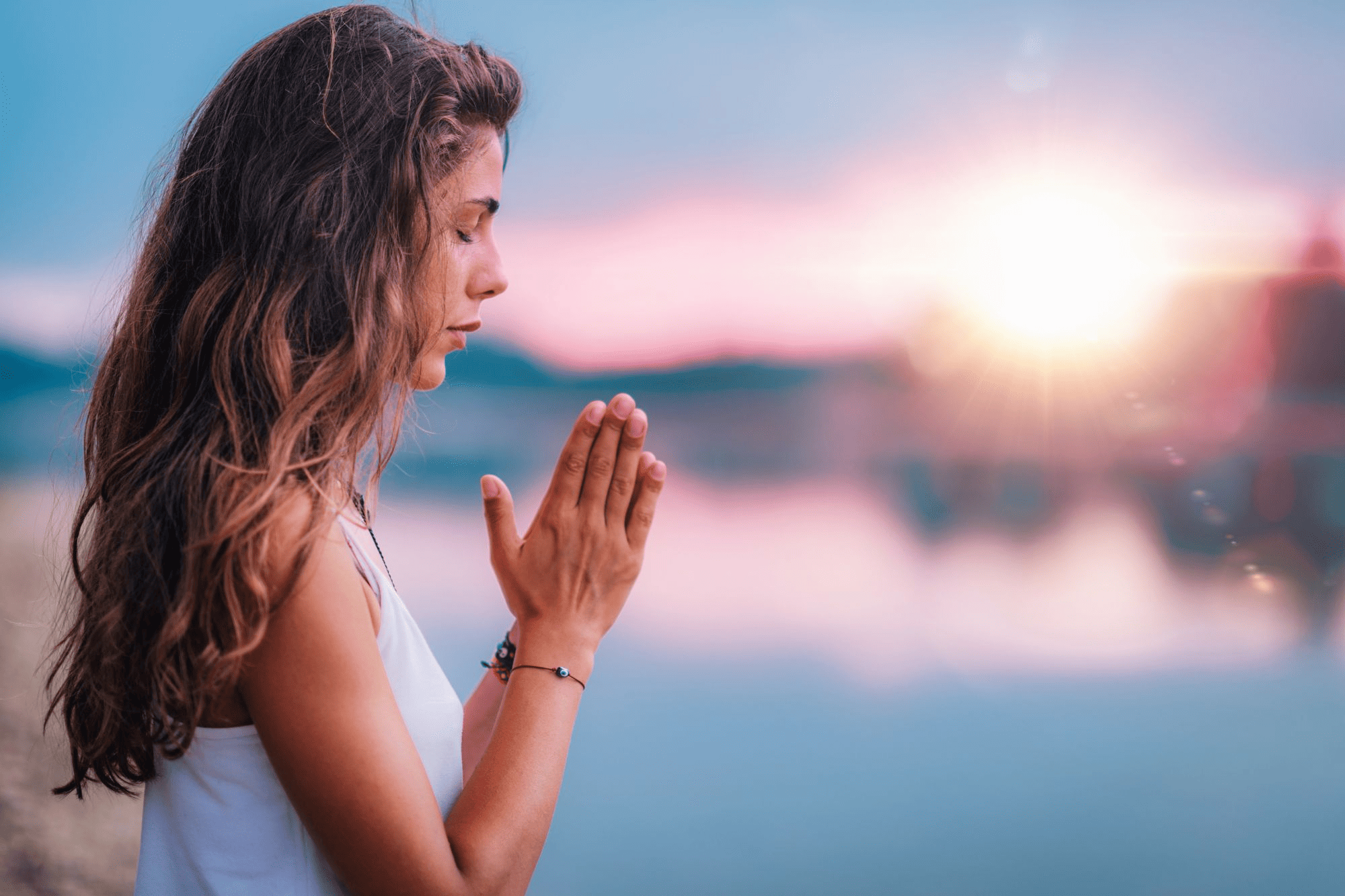 Woman with hands together praying