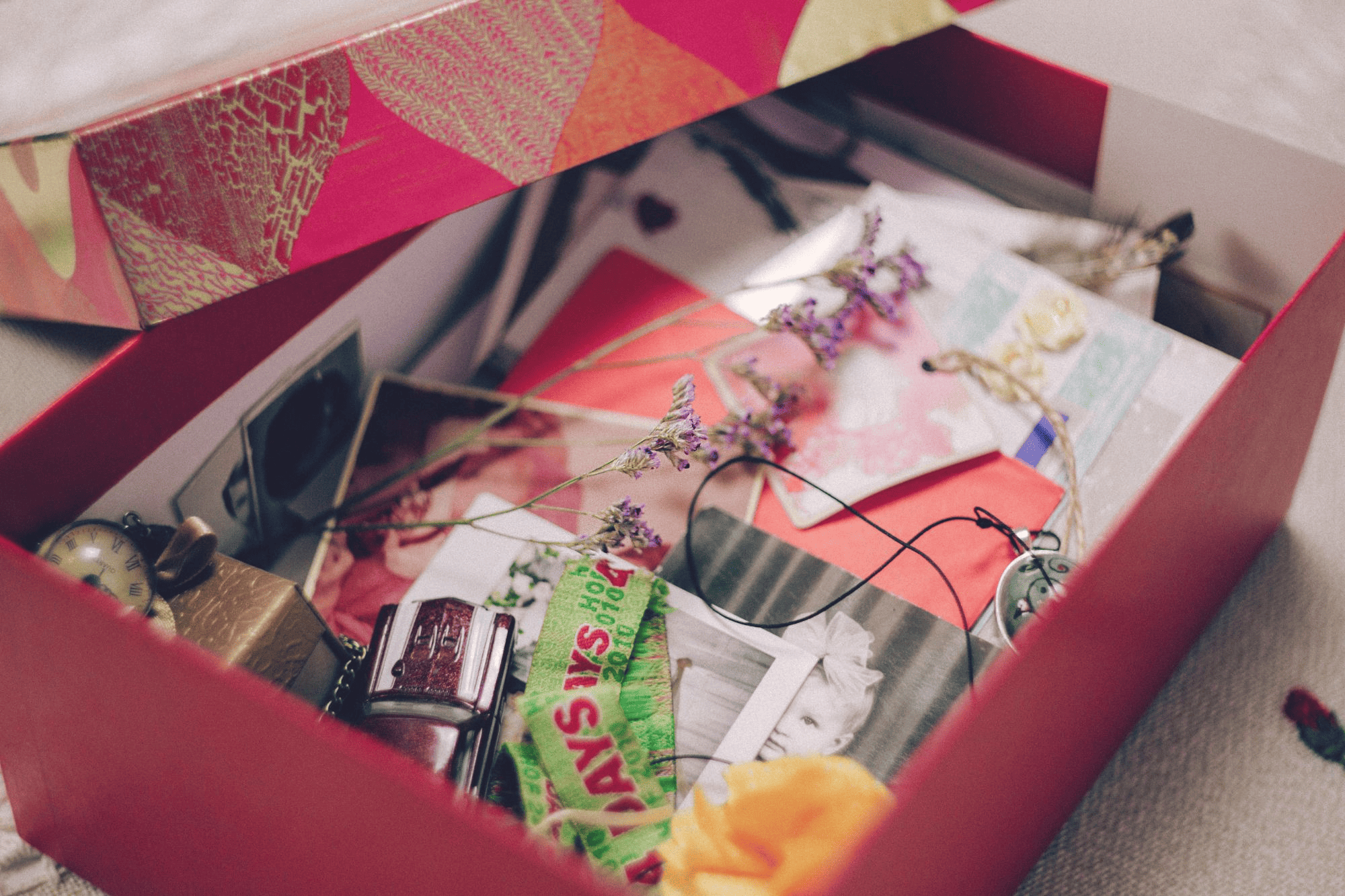 Pink paper box with various items inside