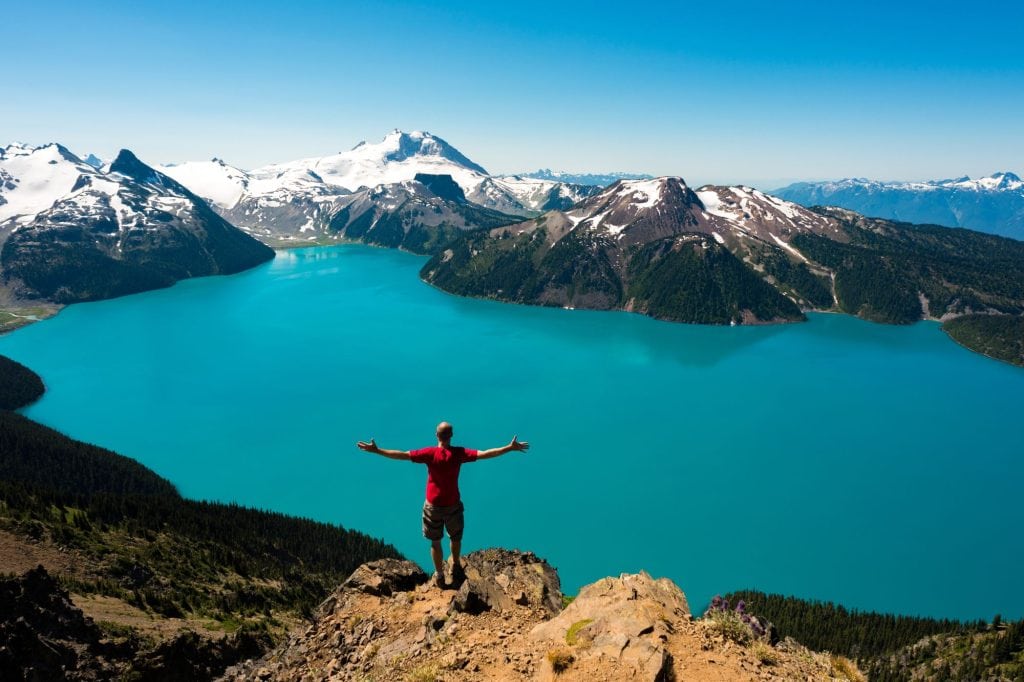 Person overlooking mountain lake