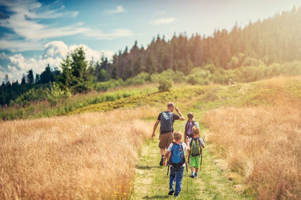family hiking in mountains